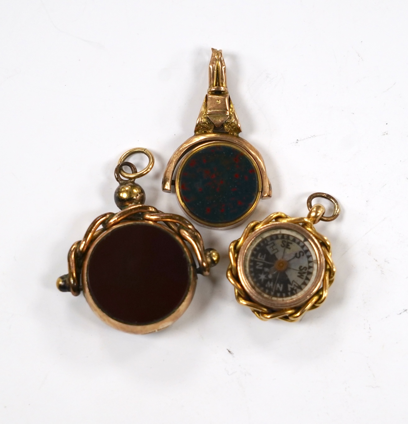 Three late Victorian carnelian set fob seals including 18ct rolled gold, largest 3mm.